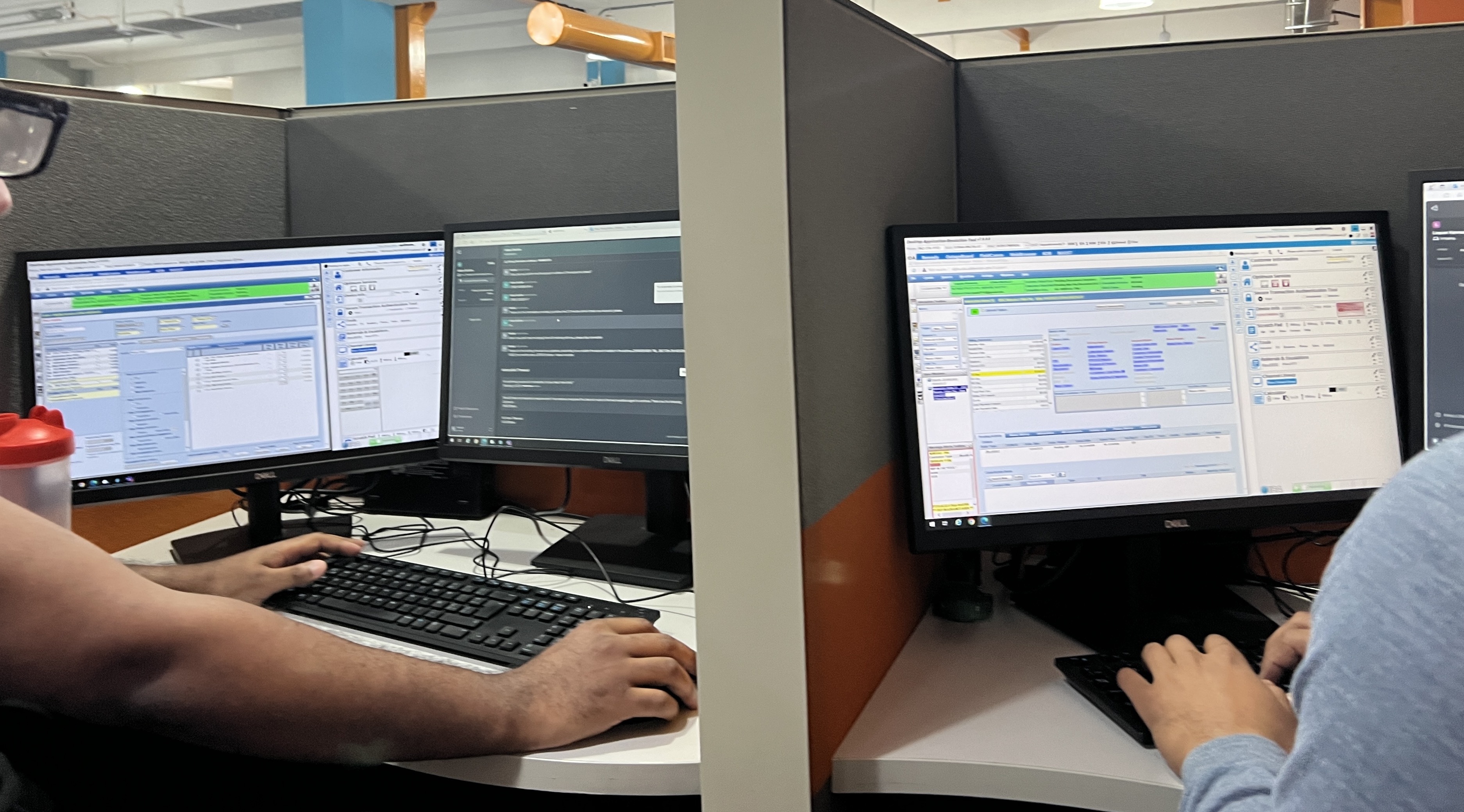 Agents working at multi-monitor desks during the contact center site visit